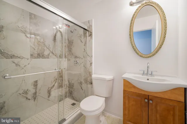 a bathroom with a sink toilet and a mirror