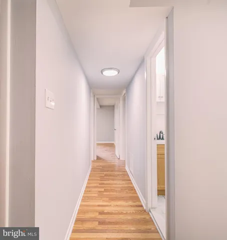 a view of a hallway with wooden floor
