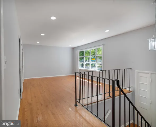 a view of hallway with wooden floor
