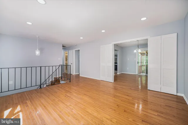 a view of an empty room with wooden floor