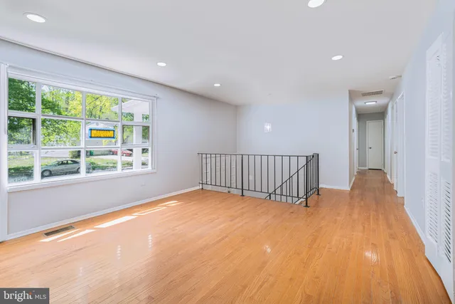 a view of a room with wooden floor and windows