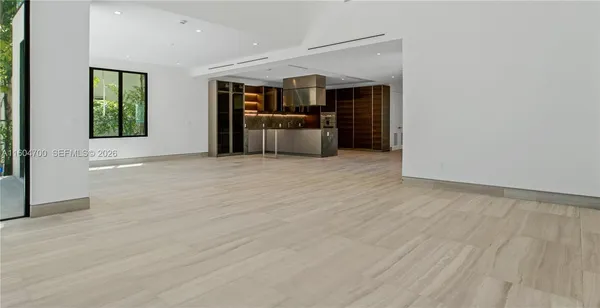 a view of a kitchen with a sink and a refrigerator
