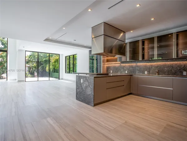 a large kitchen with stainless steel appliances granite countertop a large counter top