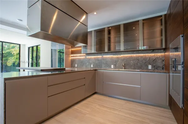 a kitchen with granite countertop cabinets and window