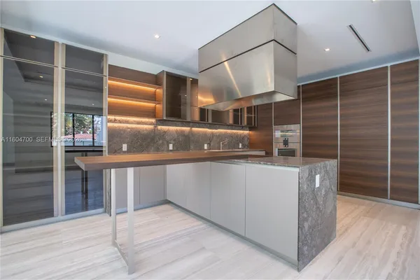 a kitchen with counter top space and wooden cabinets