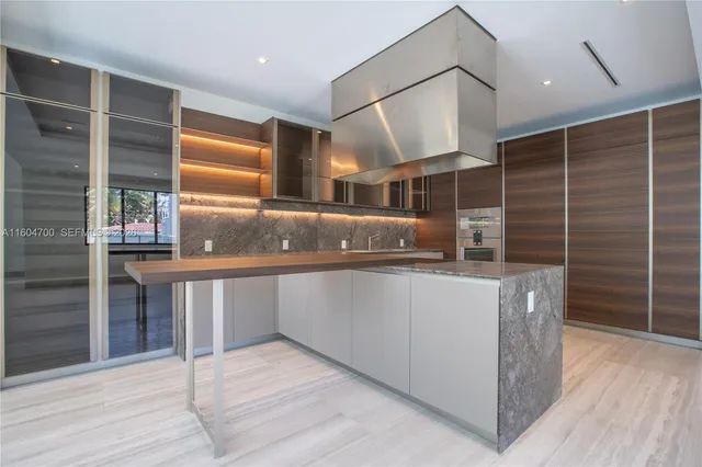 a kitchen with counter top space and wooden cabinets