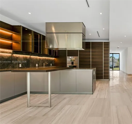 a kitchen with granite countertop a sink and cabinets