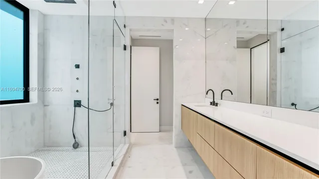 a bathroom with a tub sink mirror and toilet