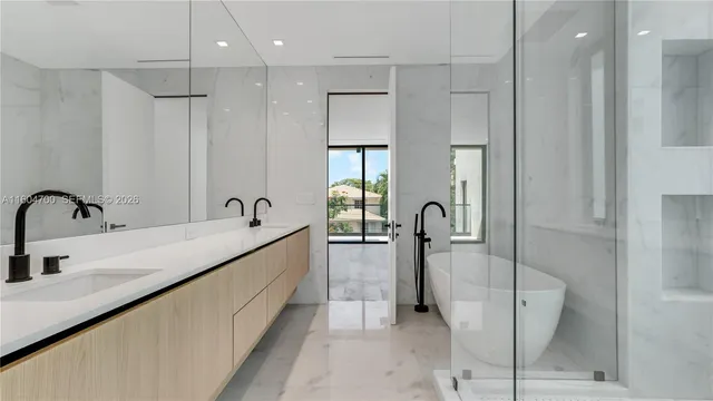 a spacious bathroom with a double sink shower and mirror