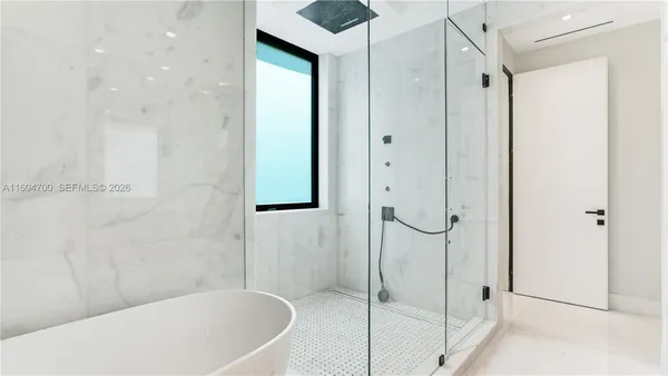 a bathroom with a bathtub and a shower