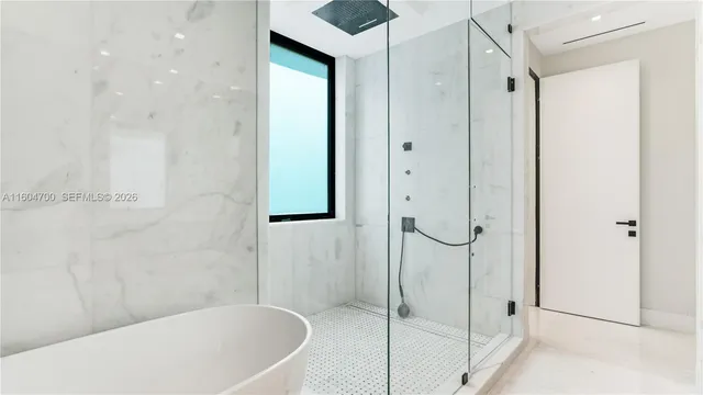 a bathroom with a bathtub and a shower