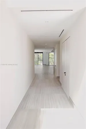 a view of a livingroom with wooden floor and windows