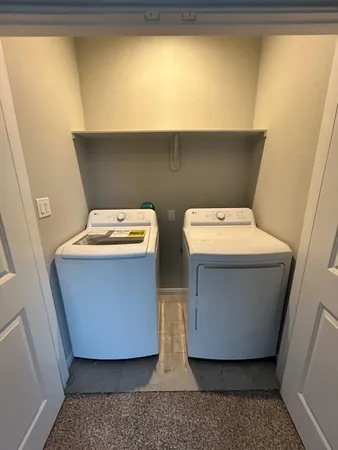a bathroom with a double vanity sink toilet and shower