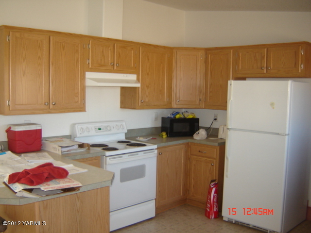 621 Hideaway Road Yakima, WA 98908 - Photo 6 of 26 a kitchen with a refrigerator sink stove and cabinets