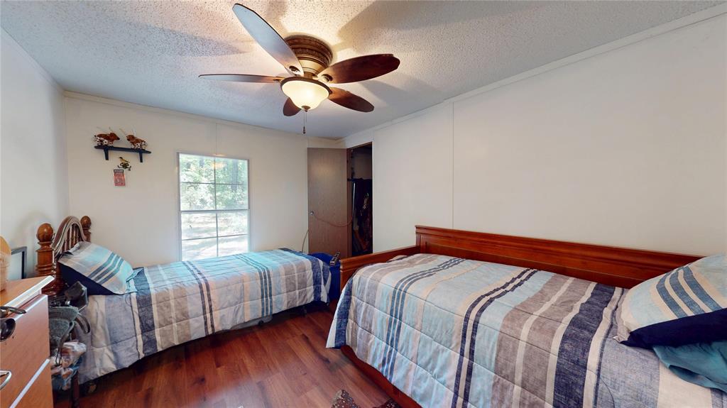 670 Arbin Culpepper Road Jonesboro, LA 71251 - Photo 13 of 17 a bedroom with two beds and a chandelier