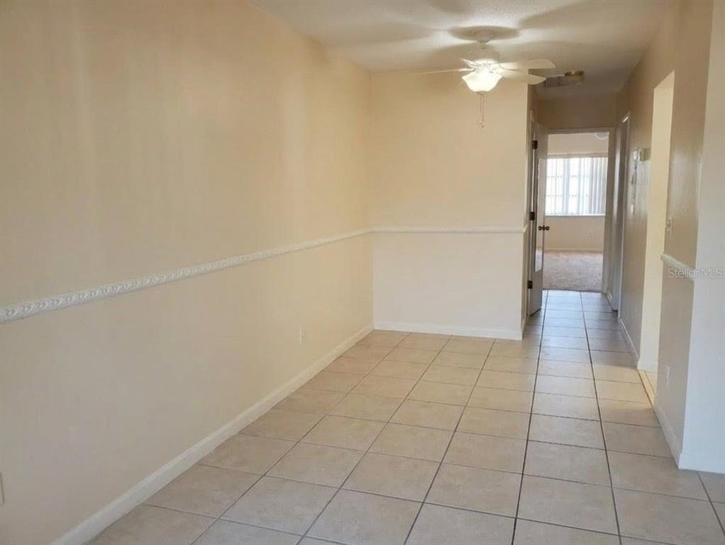 4744 Azalea Drive, Unit 204 New Port Richey, FL 34652 - Photo 3 of 20 en empty room with wooden floor and windows