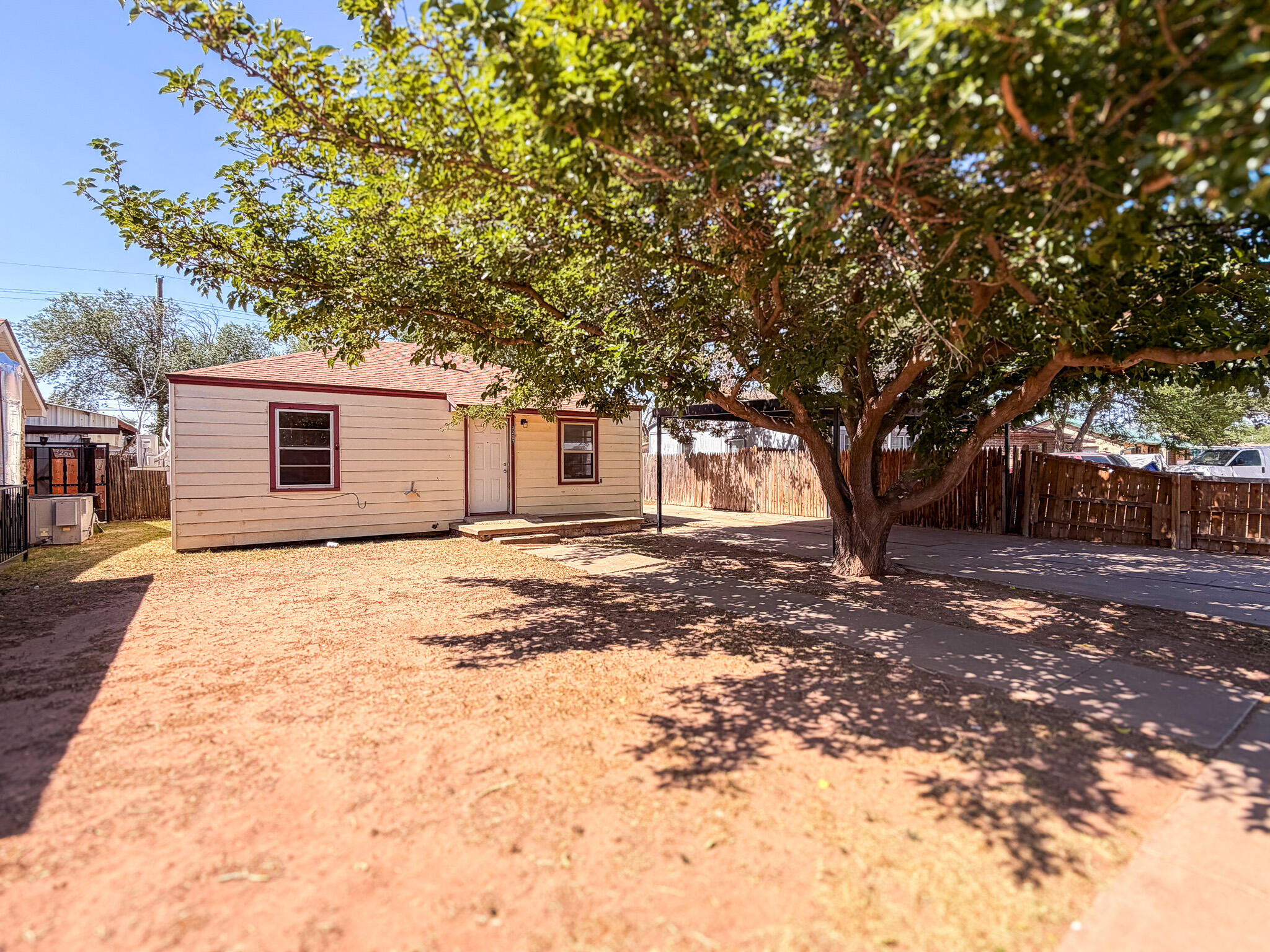 3207 Amherst Street Lubbock, TX 79415 - Photo 1 of 16 a view of a backyard with a large tree