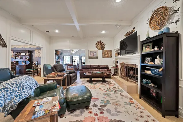 a living room with furniture a flat screen tv and a rug