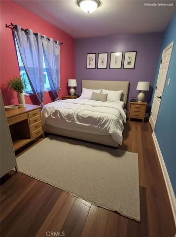 a bedroom with a bed and a large mirror on the dresser