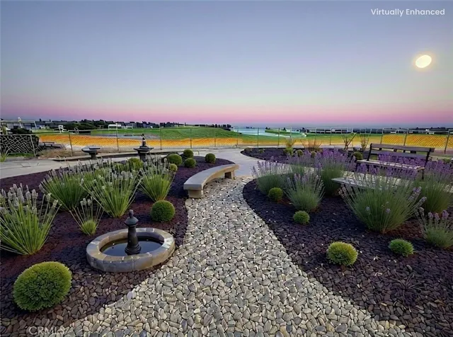 a view of a lake with a patio and a garden
