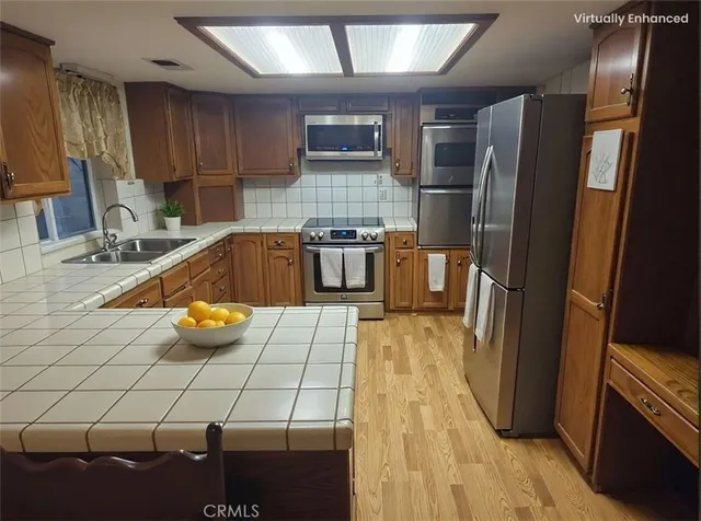 a kitchen with a sink and refrigerator