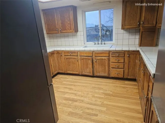 a kitchen with granite countertop a sink a stove and a microwave oven