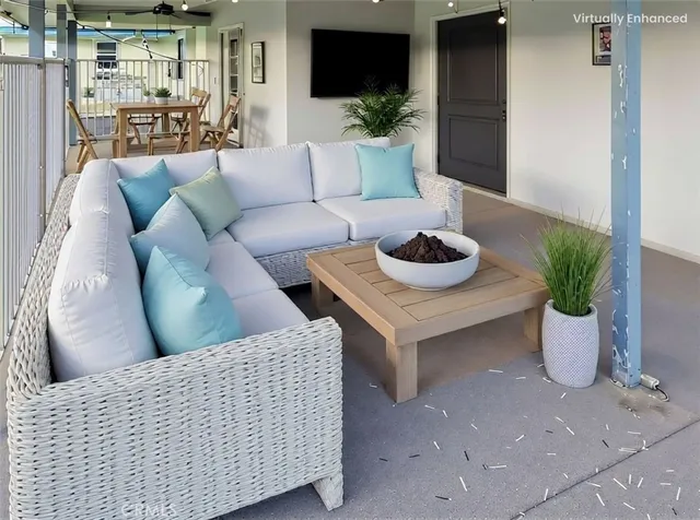 a living room with furniture and a potted plant
