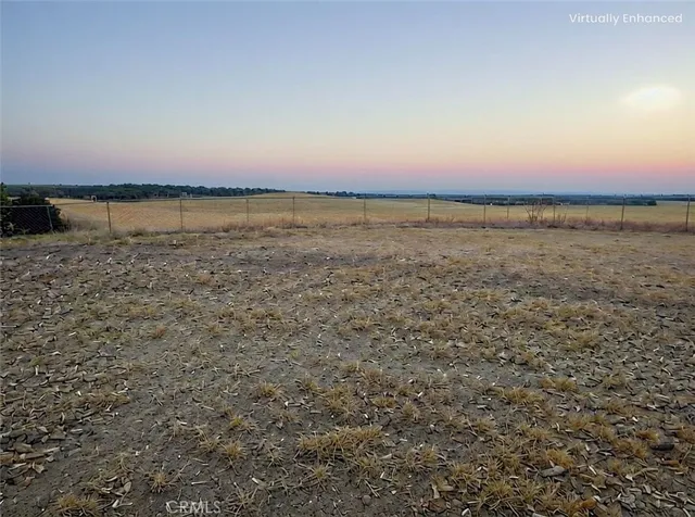 an empty room with large trees and mountain in the background