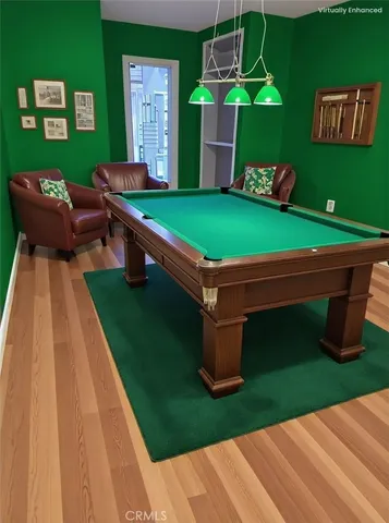 a room with pool table and windows