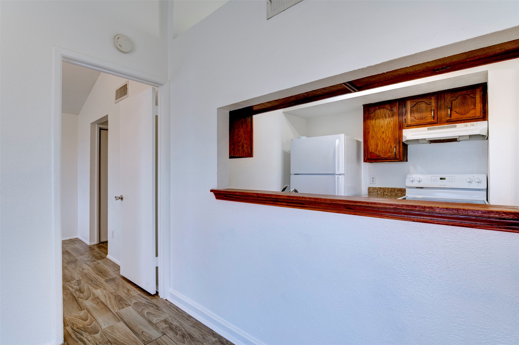 14323 Edenglen Drive Houston, TX 77049 - Photo 14 of 27 a view of a hallway with wooden floor and staircase