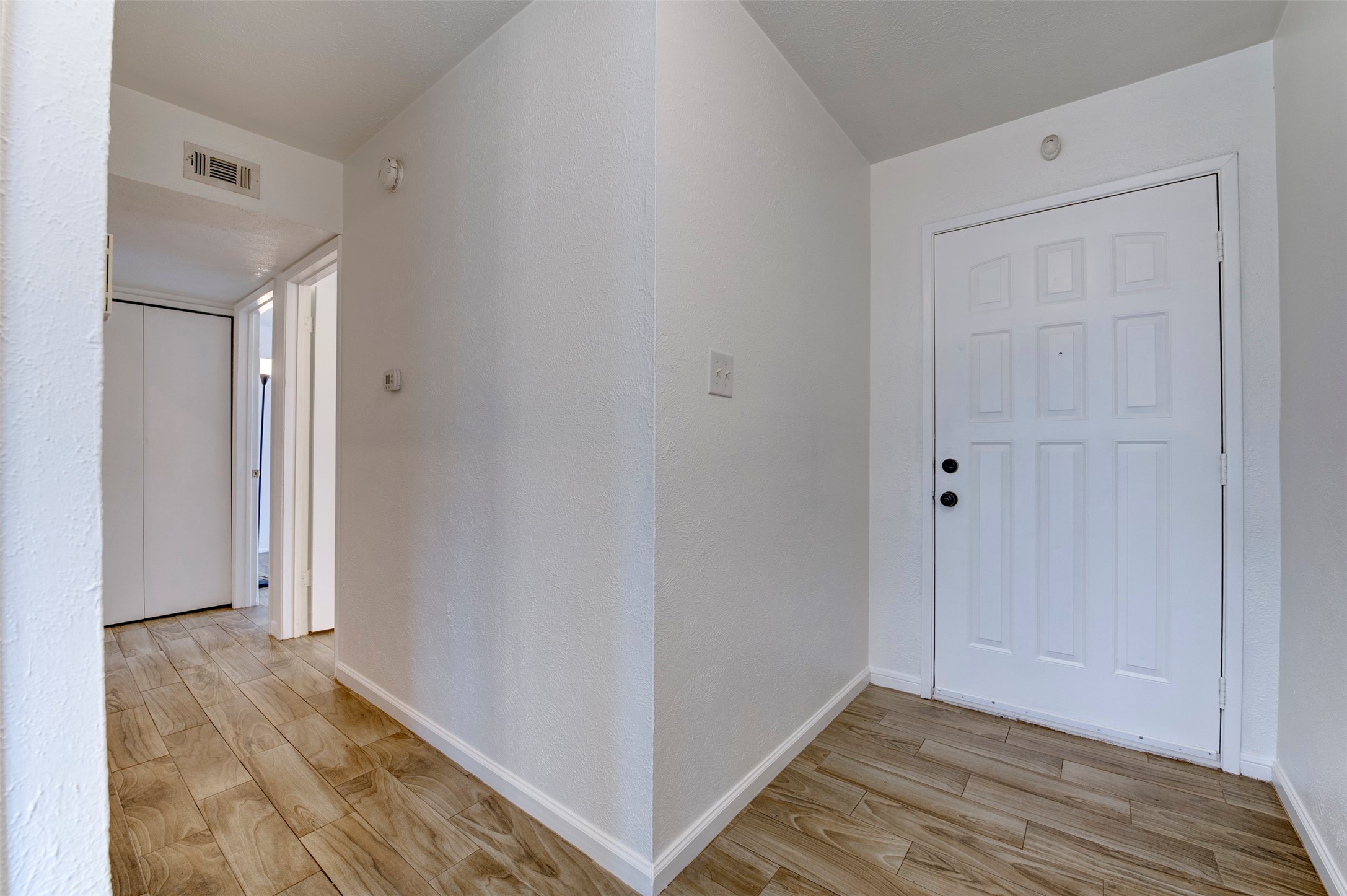 14323 Edenglen Drive Houston, TX 77049 - Photo 15 of 27 a view of hallway with wooden floor
