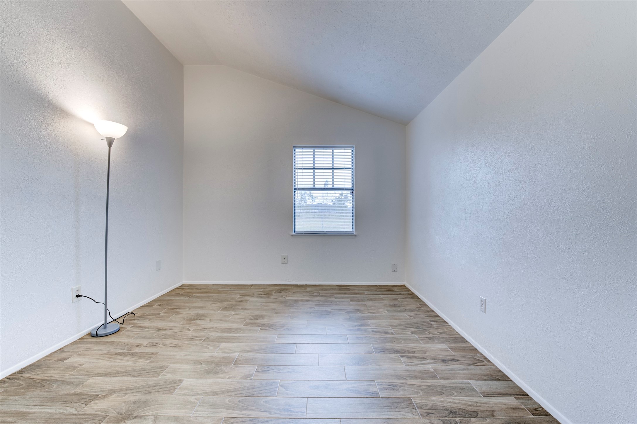 14323 Edenglen Drive Houston, TX 77049 - Photo 17 of 27 an empty room with wooden floor and windows