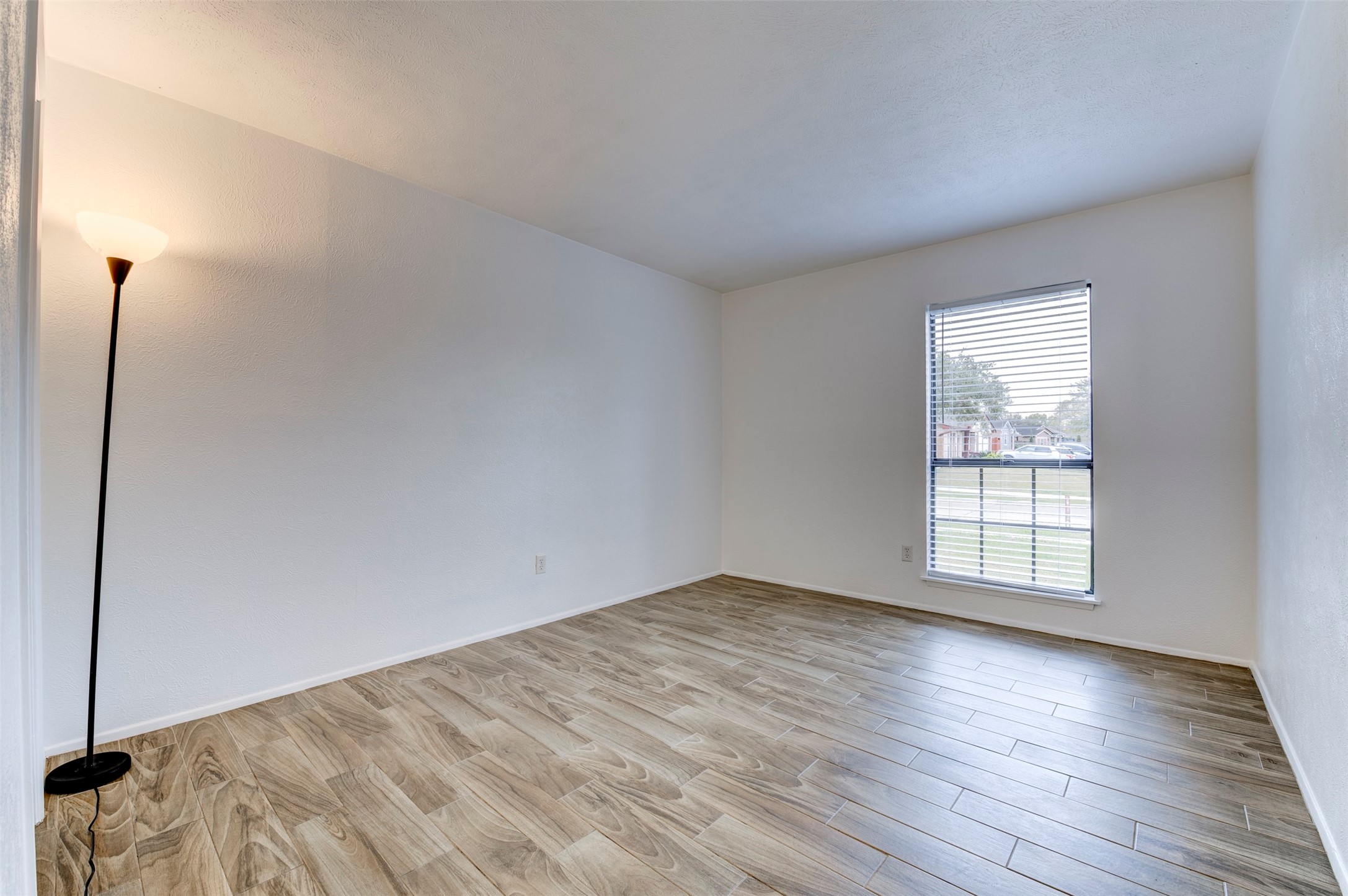 14323 Edenglen Drive Houston, TX 77049 - Photo 22 of 27 an empty room with wooden floor and window