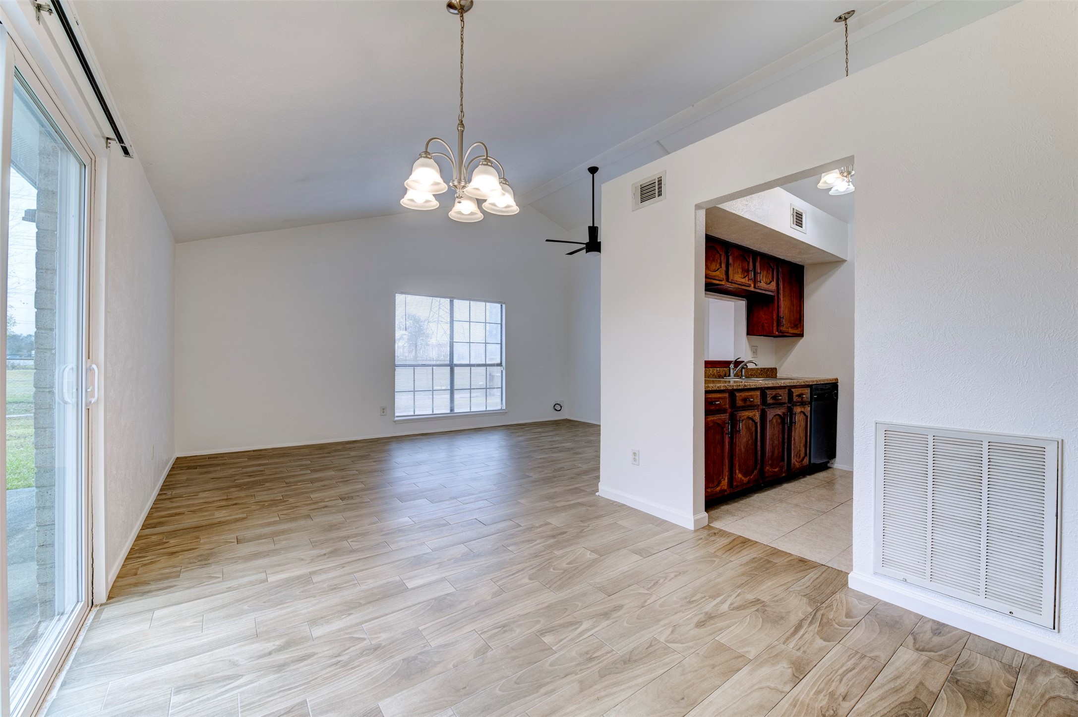 14323 Edenglen Drive Houston, TX 77049 - Photo 3 of 27 a view of a room with wooden floor and kitchen view