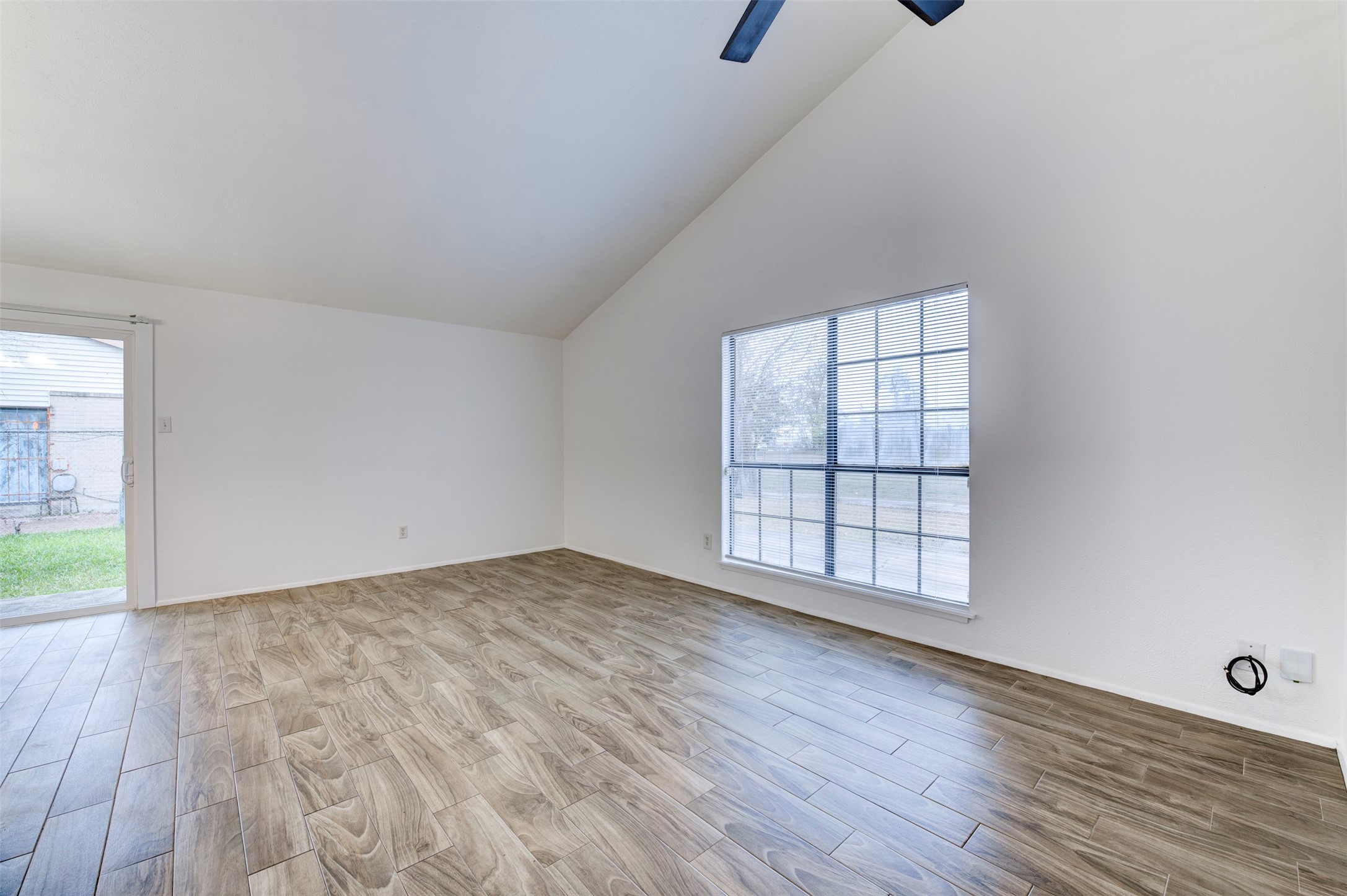 14323 Edenglen Drive Houston, TX 77049 - Photo 6 of 27 an empty room with wooden floor and windows
