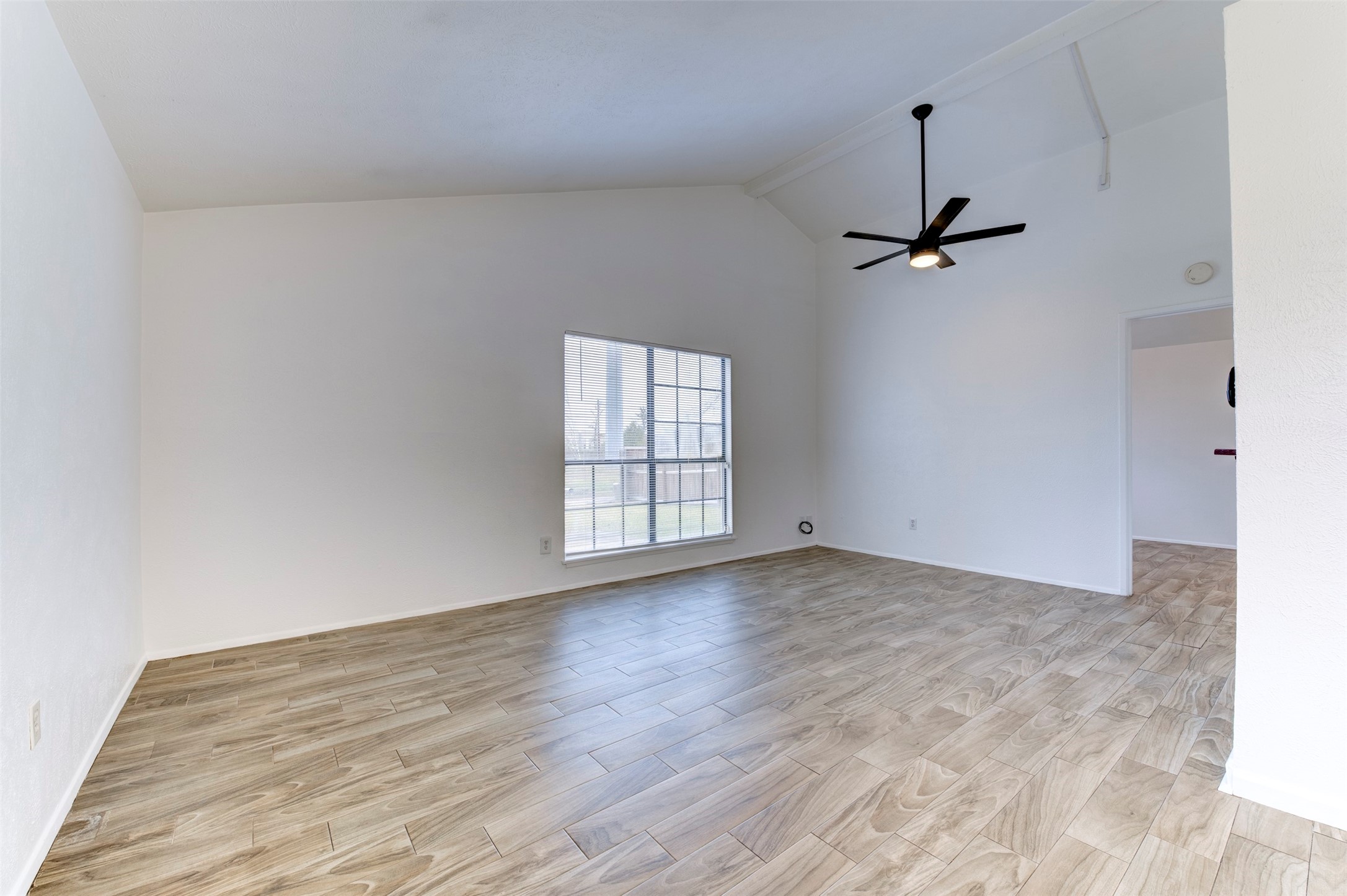 14323 Edenglen Drive Houston, TX 77049 - Photo 7 of 27 a view of empty room with wooden floor and fan