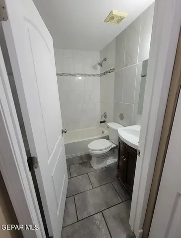 a bathroom with a sink a toilet and a shower