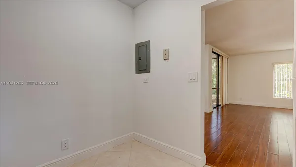 a view of room with window and wooden floor