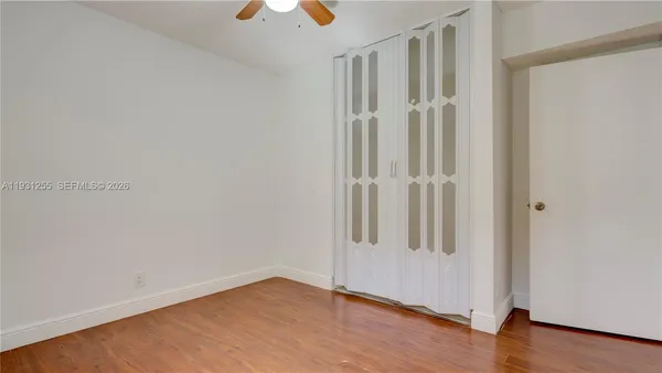 an empty room with wooden floor