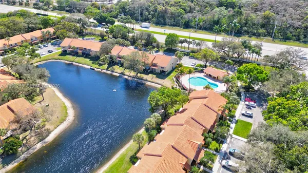 an aerial view of a houses with a yard
