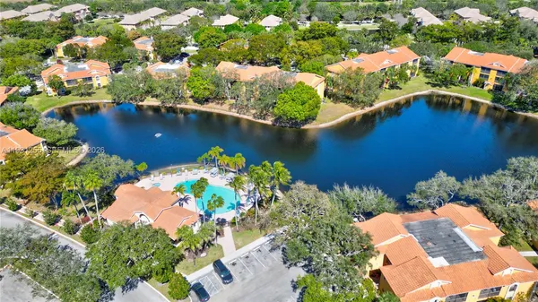 an aerial view of residential houses with outdoor space and swimming pool