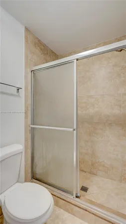 a white toilet and shower