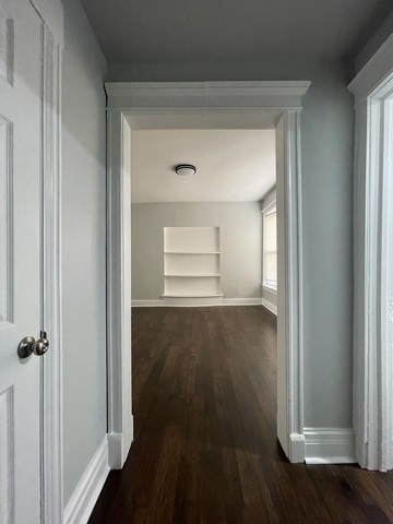 916 West 68th Street, Unit 2W Chicago, IL 60621 - Photo 2 of 8 wooden floor in an empty room