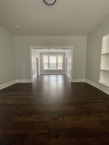 916 West 68th Street, Unit 2W Chicago, IL 60621 - Photo 3 of 8 a view of empty room with wooden floor and fan