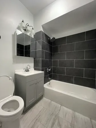 a bathroom with a sink a toilet and bathtub