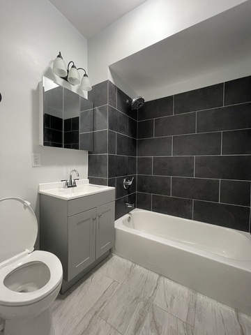 916 West 68th Street, Unit 2W Chicago, IL 60621 - Photo 8 of 8 a bathroom with a sink a toilet and bathtub