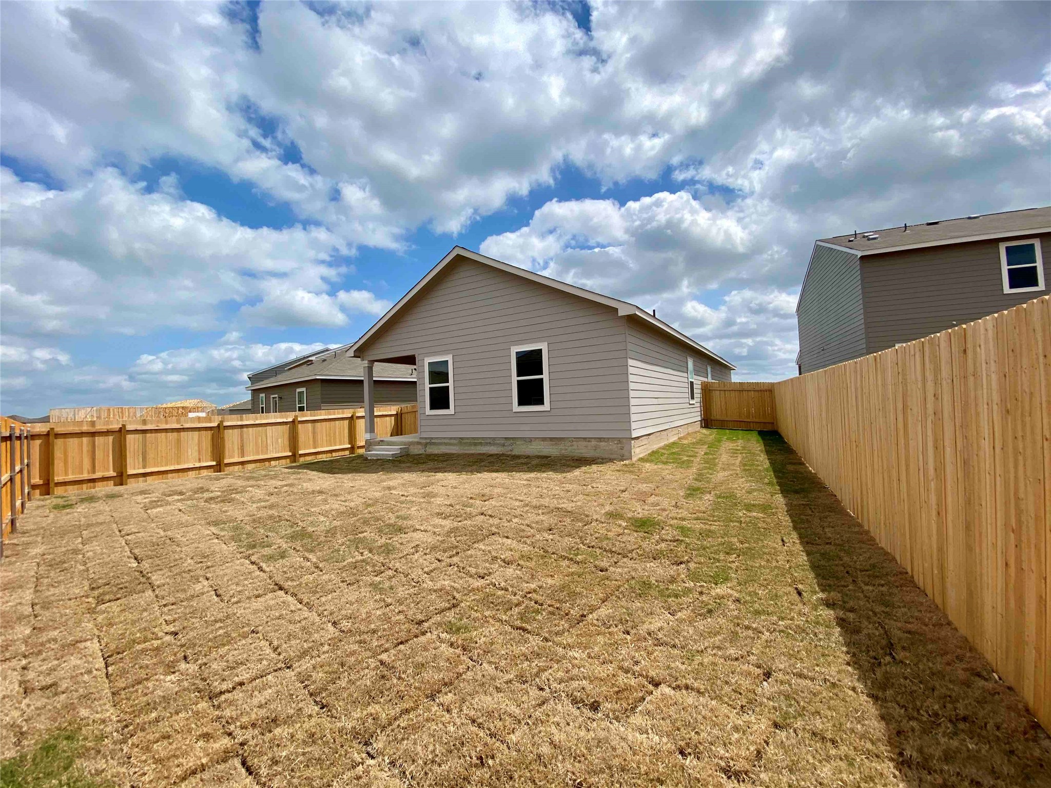 360 Bell Rings Drive Jarrell, TX 76537 - Photo 9 of 10 A well-defined backyard offers privacy with new fencing and ample space for outdoor activities.