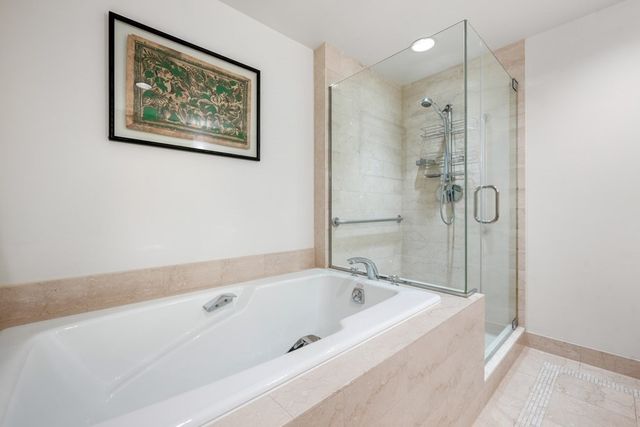 a bathroom with a bathtub and a shower