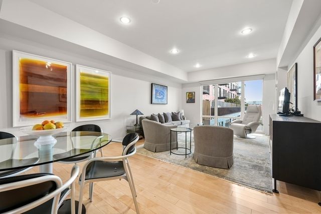 a living room with fireplace furniture and a large window