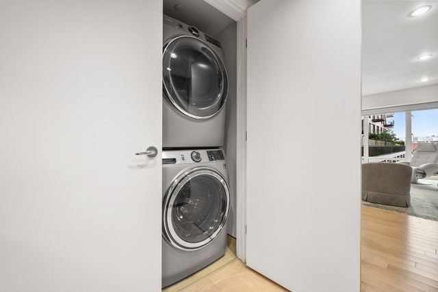 a view of a hallway with washer and dryer